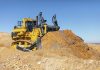 Komatsu D475A-8 pushing material with its blade