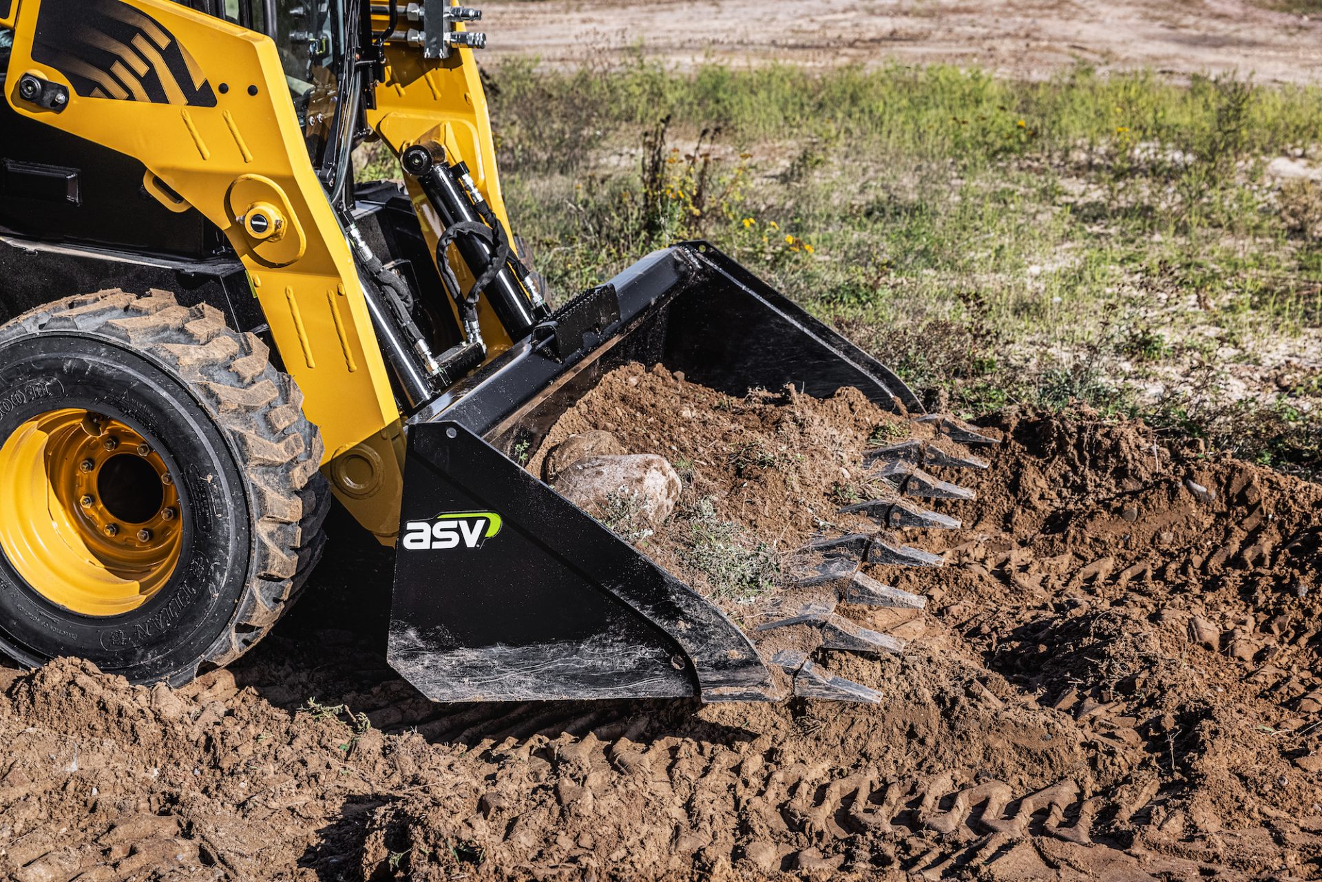 An ASV skid steer with a bucket attachment from the company's new line of attachments.