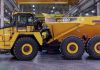A komatsu HM400-5 articulated haul truck is parked in a facility