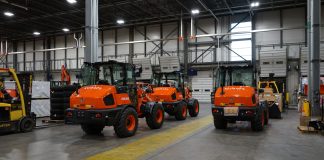 Kubota machines sit parked in a warehouse