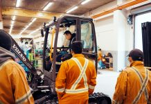 Vancouver Community College students learn about an electric excavator