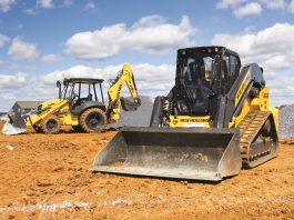 New Holland loader and backhoe sit on a construction site