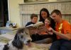 A family reads the book Where Does Daddy Go All Day?