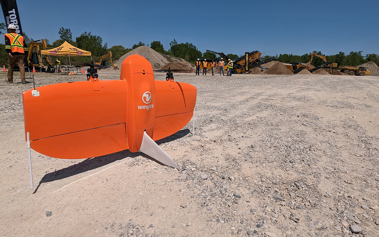 A Wingtra mapping drone lands on a quarry site