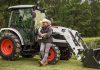 Justin Moore stands in front of a Bobcat tractor