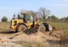 A JCB wheel loader moves dirt