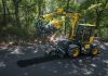 The JCB pothole pro completes a road repair in a treed area