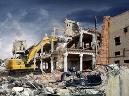 Cat 330 straight boom excavator demolishes a building